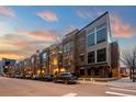 Street view showcases modern brick townhomes with rooftop decks and sleek architectural details on a quiet street at 2900 Inca St # 7, Denver, CO 80202