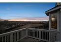Relax on this backyard deck and enjoy panoramic views of the sunset over the distant city skyline at 3738 Black Feather Trl, Castle Rock, CO 80104