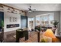 Modern living room boasts a sleek fireplace, bright windows, and comfortable seating for Gathering and guests at 3738 Black Feather Trl, Castle Rock, CO 80104
