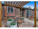 Inviting front entrance featuring a cozy bench and stylish pergola for a warm welcome at 17372 E Prentice Cir, Centennial, CO 80015