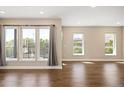 Bright and airy living room featuring hardwood floors and large windows at 2374 S University Blvd # 202, Denver, CO 80210