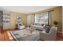 Bright living room with hardwood floors, a large window, and stylish decor creating a welcoming atmosphere at 2237 S Lowell Blvd, Denver, CO 80219