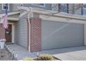 A welcoming home exterior featuring brick accents, and a well-lit walkway at 5936 Turnstone Pl, Castle Rock, CO 80104