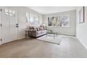 Bright living room featuring light wood floors, neutral paint, and abundant natural light at 3550 Fairfax St, Denver, CO 80207