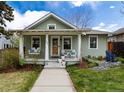 Inviting front porch with seating, perfect for relaxing and enjoying the beautifully landscaped front yard at 2074 S Emerson St, Denver, CO 80210