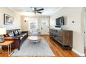 Bright living room featuring hardwood floors, a ceiling fan, and a decorative rug at 2074 S Emerson St, Denver, CO 80210