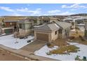 Modern home with a three-car garage and views of the surrounding landscape at 9524 Fork Bluff Pt, Lone Tree, CO 80124