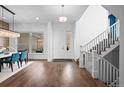 Bright and spacious entryway with hardwood floors and a staircase at 9524 Fork Bluff Pt, Lone Tree, CO 80124