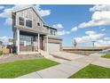 Stylish two-story home with a modern design, featuring a covered porch and two-car garage at 21295 E 61St Dr, Aurora, CO 80019