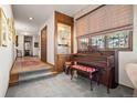 Inviting entryway featuring a piano, built-in display cabinet, and neutral-toned decor at 2851 Interlocken Dr, Evergreen, CO 80439