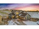 Charming two-story home with an attached garage and a picturesque snow-covered landscape at sunset at 8086 S Grand Baker Way, Aurora, CO 80016