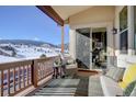 Relaxing outdoor balcony with comfortable seating, offering scenic views of the mountains at 4502 Echo Cliff Ln, Larkspur, CO 80118