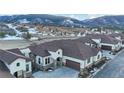 Stunning stucco home with stone accents, a spacious driveway, and beautiful mountain views at 4502 Echo Cliff Ln, Larkspur, CO 80118