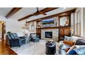 Comfortable living room with stone fireplace, wood accents, and stylish furnishings creating a cozy atmosphere at 4502 Echo Cliff Ln, Larkspur, CO 80118