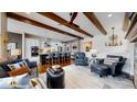 Open-concept living room with hardwood floors, a stylish kitchen island, and comfortable seating at 4502 Echo Cliff Ln, Larkspur, CO 80118