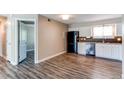 Contemporary kitchen features white cabinets, stainless steel appliances, and modern flooring at 5250 S Huron Way # 10-207, Littleton, CO 80120