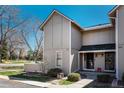 A well-maintained two-story townhouse exterior shows green lawn and an inviting entrance at 2699 S Xanadu Way # A, Aurora, CO 80014