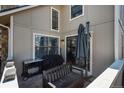 Cozy patio area with a grill, bench, and shade umbrella offering a relaxing outdoor space at 2699 S Xanadu Way # A, Aurora, CO 80014