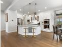 Bright, modern kitchen with a spacious island, stainless steel appliances, and hardwood floors at 9378 E 60Th Pl, Denver, CO 80238