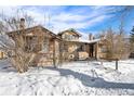 Cozy brick home with charming details and a snowy yard creates a picturesque winter scene at 2222-2224 Hooker St, Denver, CO 80211