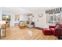 Bright living room with hardwood floors, a cozy sofa, and a door leading outside at 2222-2224 Hooker St, Denver, CO 80211