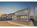 Spacious backyard featuring a covered patio, perfect for outdoor entertaining and relaxation at 8903 Springsong Ln, Littleton, CO 80125