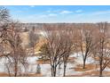 Beautiful neighborhood view with mature trees and a park in the distance at 2990 E 17Th Ave # 1102, Denver, CO 80206