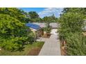 Aerial view of brick home with solar panels, manicured lawn, long driveway and attached garage at 216 Hemlock, Broomfield, CO 80020