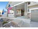 Inviting front porch with decorative columns, perfect for enjoying a morning coffee at 8796 E 150Th Ct, Thornton, CO 80602