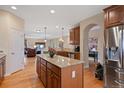 Open kitchen featuring granite countertops, stainless steel appliances, and rich wood cabinetry at 8796 E 150Th Ct, Thornton, CO 80602