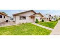 A charming home features a well-manicured lawn and a welcoming pathway, enhancing its curb appeal at 23 Carla Way, Broomfield, CO 80020