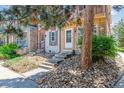 Inviting townhouse exterior with stone detailing, front yard landscaping, and a cozy entrance at 12059 E Hoye Dr, Aurora, CO 80012