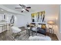 Cozy living room featuring a comfortable sofa, modern decor, and hardwood floors, perfect for relaxation at 5873 Ceylon St # E, Denver, CO 80249
