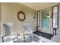 Inviting front porch with rocking chairs, seasonal wreaths, and decorative lanterns at 6112 Alkire Ct, Arvada, CO 80004