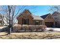 Charming single-story home with a stone and stucco exterior and well-maintained landscaping at 2238 Calais Dr # B, Longmont, CO 80504