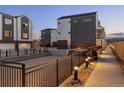 Community sand volleyball court surrounded by modern townhomes and exterior lighting at 4511 Tabor St, Wheat Ridge, CO 80033