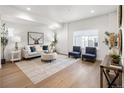 Bright living room featuring hardwood floors, neutral walls, stylish furniture, and natural light at 4511 Tabor St, Wheat Ridge, CO 80033