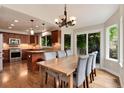 Eat-in kitchen with dining table and chairs, slider patio door and view of the backyard at 11056 W Rowland Ave, Littleton, CO 80127
