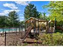 Playground with slides and climbing equipment next to a pool and picnic area for Gathering recreation and enjoyment at 11056 W Rowland Ave, Littleton, CO 80127