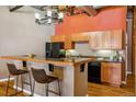 Stylish kitchen with granite countertops, stainless steel appliances, and a breakfast bar with seating at 1745 Wazee St # 4G, Denver, CO 80202