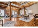 Spacious living room featuring exposed brick, wooden beams, and hardwood floors, creating a rustic-chic ambiance at 1745 Wazee St # 4G, Denver, CO 80202