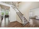 Bright foyer featuring a staircase with carpeted treads and wooden floors at 1762 Red Fox Pl, Highlands Ranch, CO 80126