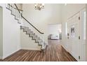 Inviting foyer with wood flooring and a staircase leading to the upper level at 1762 Red Fox Pl, Highlands Ranch, CO 80126