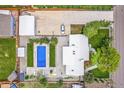Aerial view of property showcasing pool, patio, garage, and well-manicured landscaping at 2981 Teller St, Wheat Ridge, CO 80033