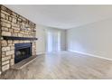 Bright living room with a stone fireplace and neutral flooring at 18193 E Kentucky Ave # 204, Aurora, CO 80017