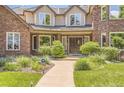 Beautiful brick home with manicured front yard, mature landscaping, and double-door entrance at 4681 S Columbine Ct, Cherry Hills Village, CO 80113