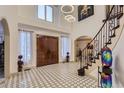 Stunning foyer with soaring ceilings, grand staircase and beautiful tile floor at 4681 S Columbine Ct, Cherry Hills Village, CO 80113