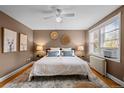 Cozy bedroom with a ceiling fan, ample natural light, and a radiator at 2867 Jasmine St, Denver, CO 80207
