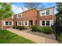 Charming brick townhome with well-maintained landscaping, offering an inviting curb appeal in a desirable neighborhood at 2867 Jasmine St, Denver, CO 80207