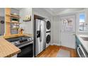 Efficient kitchen layout with stainless steel appliances and convenient washer/dryer combo at 2867 Jasmine St, Denver, CO 80207